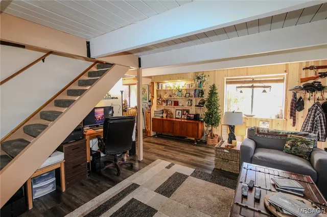 a view of a livingroom with furniture and a window