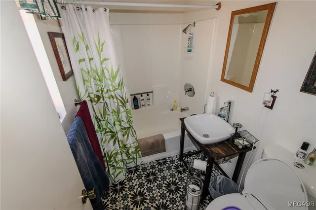 a bathroom with a toilet and a mirror