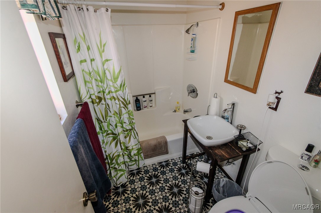 699 Santa Barbara Avenue Sugarloaf, CA 92386 - Photo 13 of 35 a bathroom with a toilet and a mirror