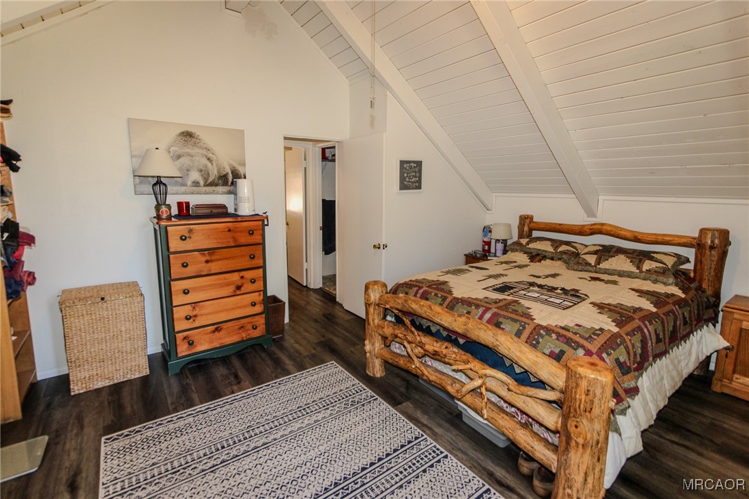699 Santa Barbara Avenue Sugarloaf, CA 92386 - Photo 16 of 35 a bedroom with a bed and wooden floor