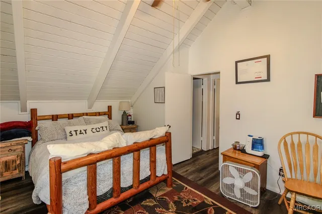 a bed room with a bed and a chair