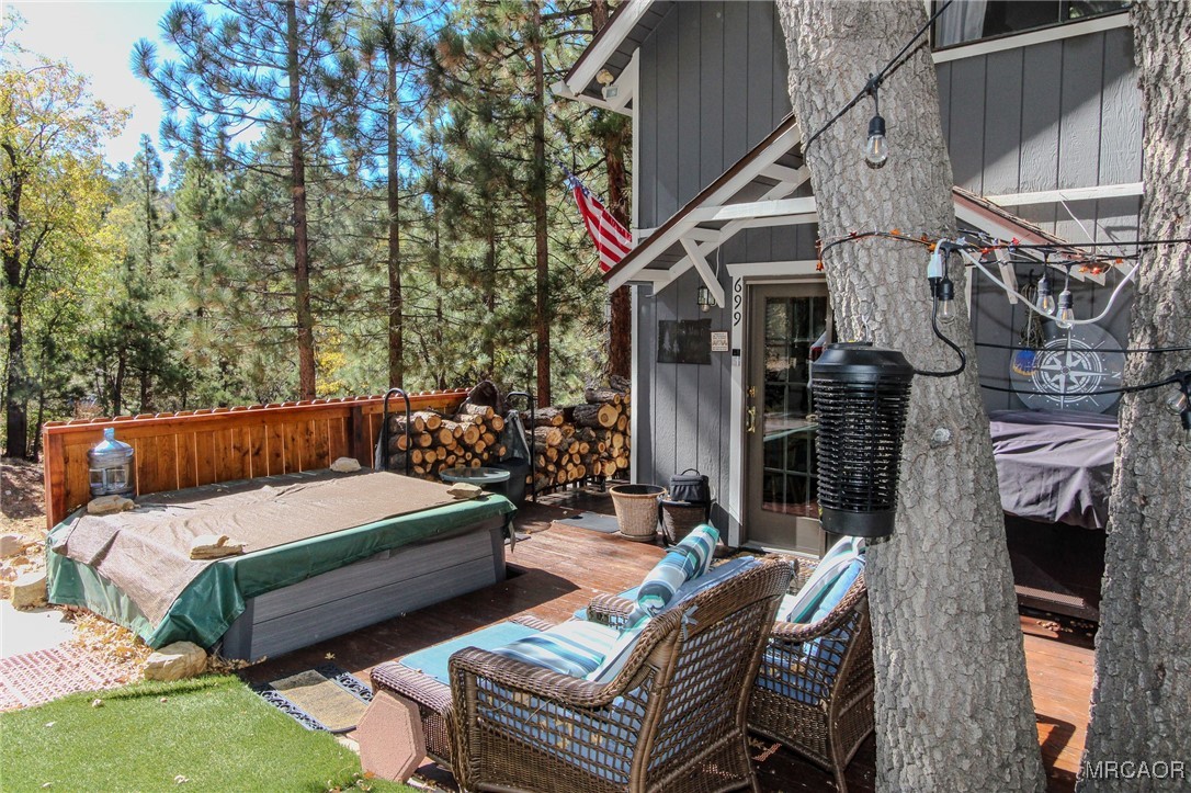 699 Santa Barbara Avenue Sugarloaf, CA 92386 - Photo 28 of 35 a view of a patio with couches table and chairs and potted plants