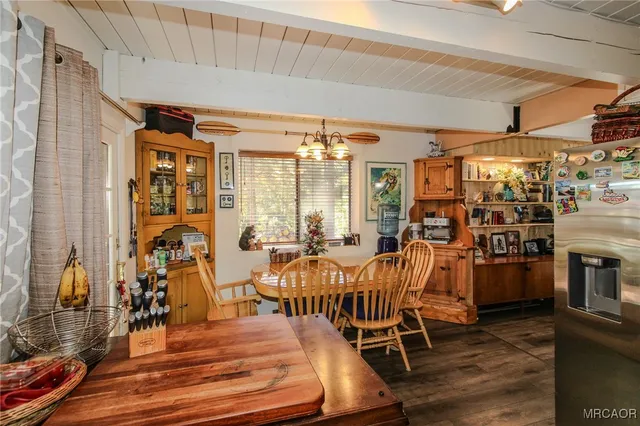 a view of a dining room with furniture and chandelier