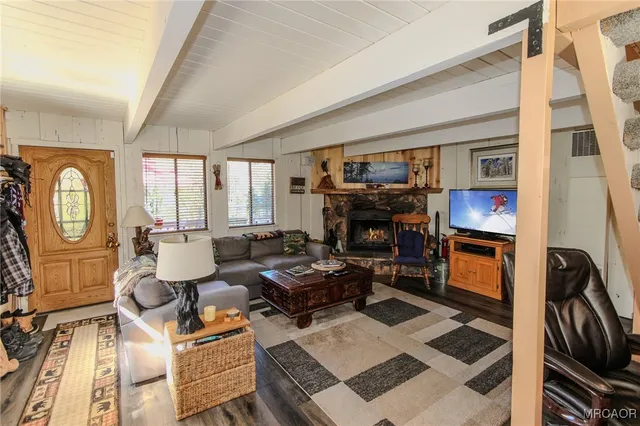 a living room with furniture a rug and a window