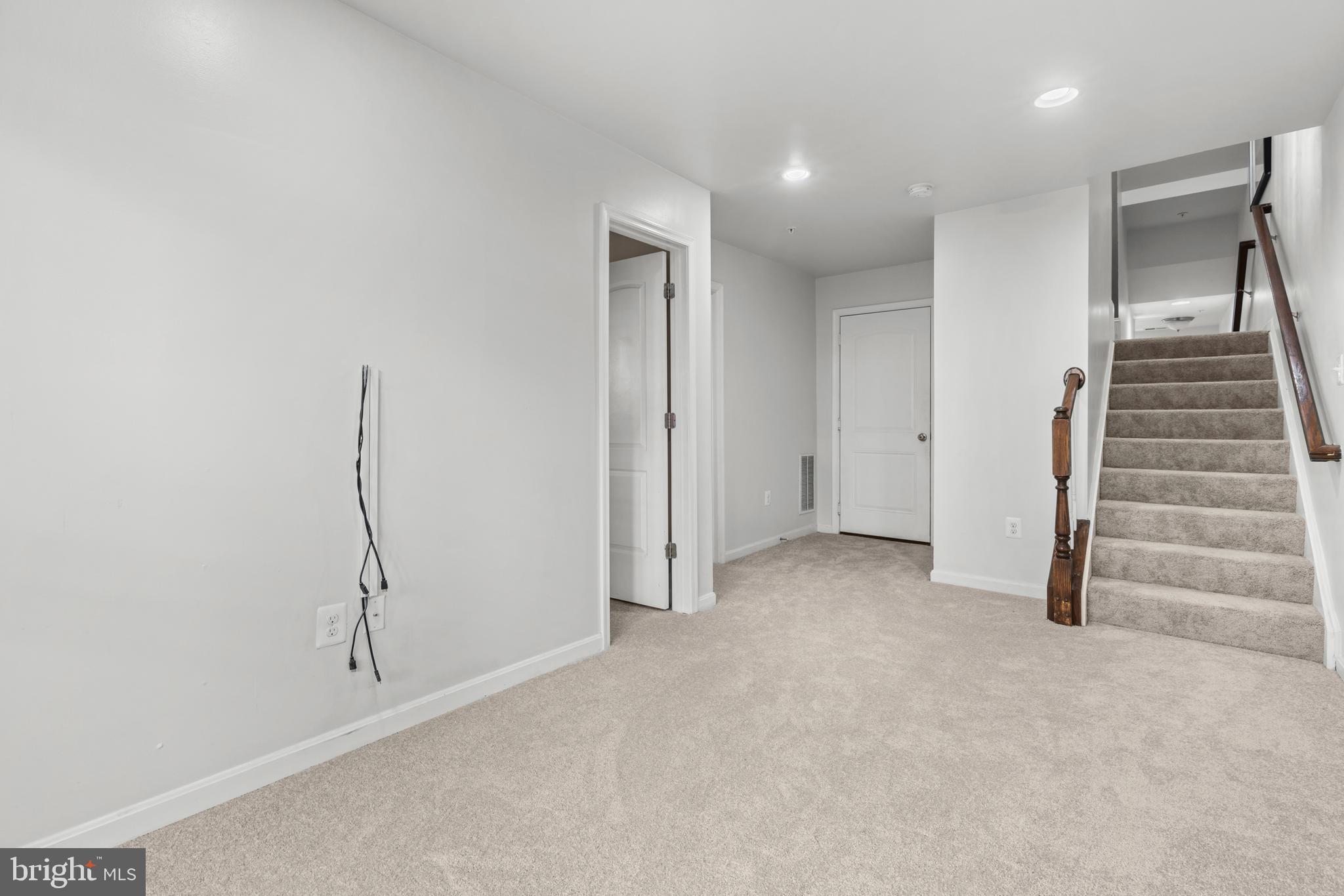 6552 Britannic Place Frederick, MD 21703 - Photo 26 of 34 an empty room with a hallway and stairs