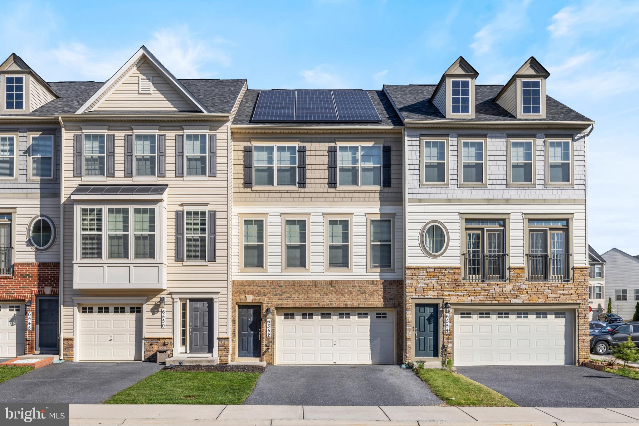 6552 Britannic Place Frederick, MD 21703 - Photo 3 of 34 a front view of a house with a yard