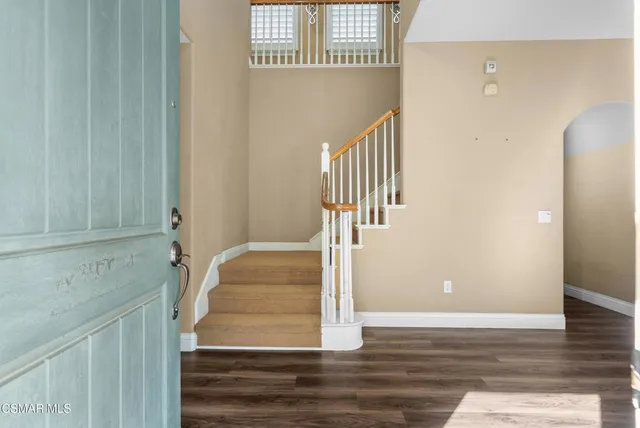 a view of entryway and hall with wooden floor