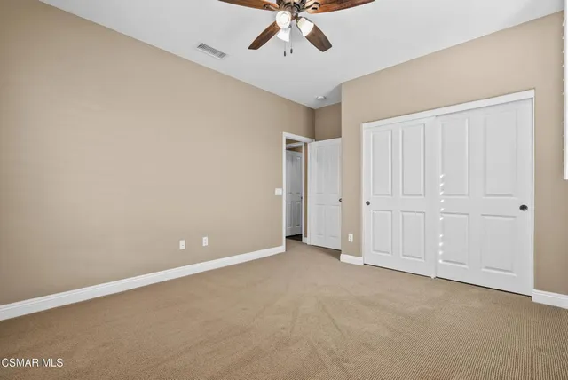 a front view of a house with a yard and potted plants