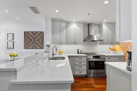 a kitchen with stainless steel appliances granite countertop a stove a sink a microwave a counter top and cabinets