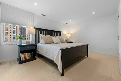 a bed room with a bed and a window