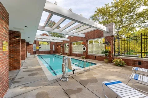 a view of a backyard with furniture and iron fence
