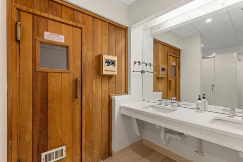 a bathroom with a double vanity sink and a mirror