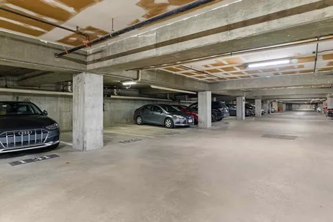 a view of parking garage with cars
