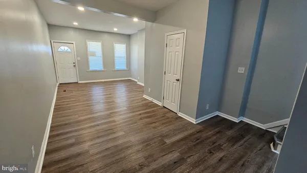 a view of a hallway with wooden floor