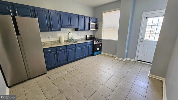 a kitchen with a refrigerator and cabinets