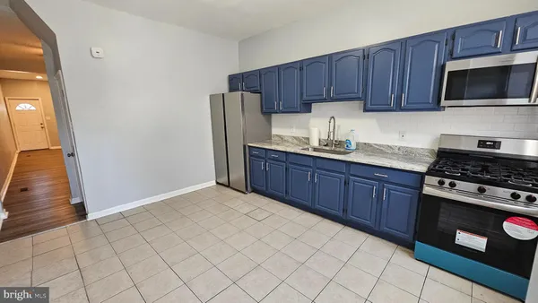 a kitchen with stainless steel appliances wooden cabinets and a stove top oven