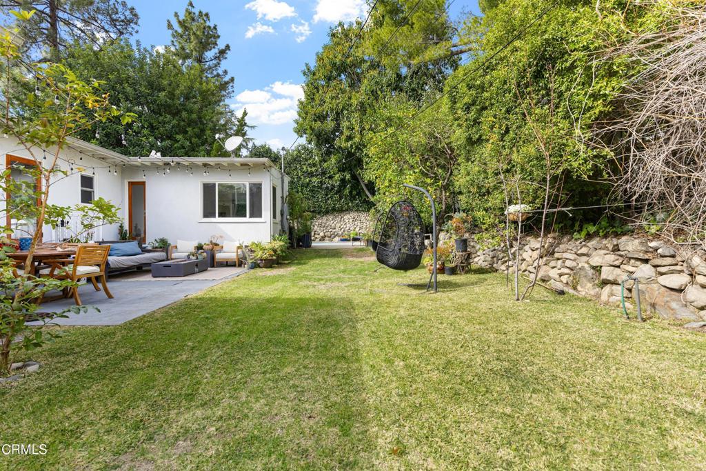 3323 Reta Street La Crescenta, CA 91214 - Photo 5 of 18 a view of a backyard with table and chairs potted plants and a large tree