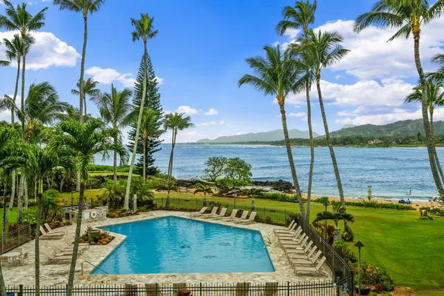 a view of a swimming pool with a table and chairs