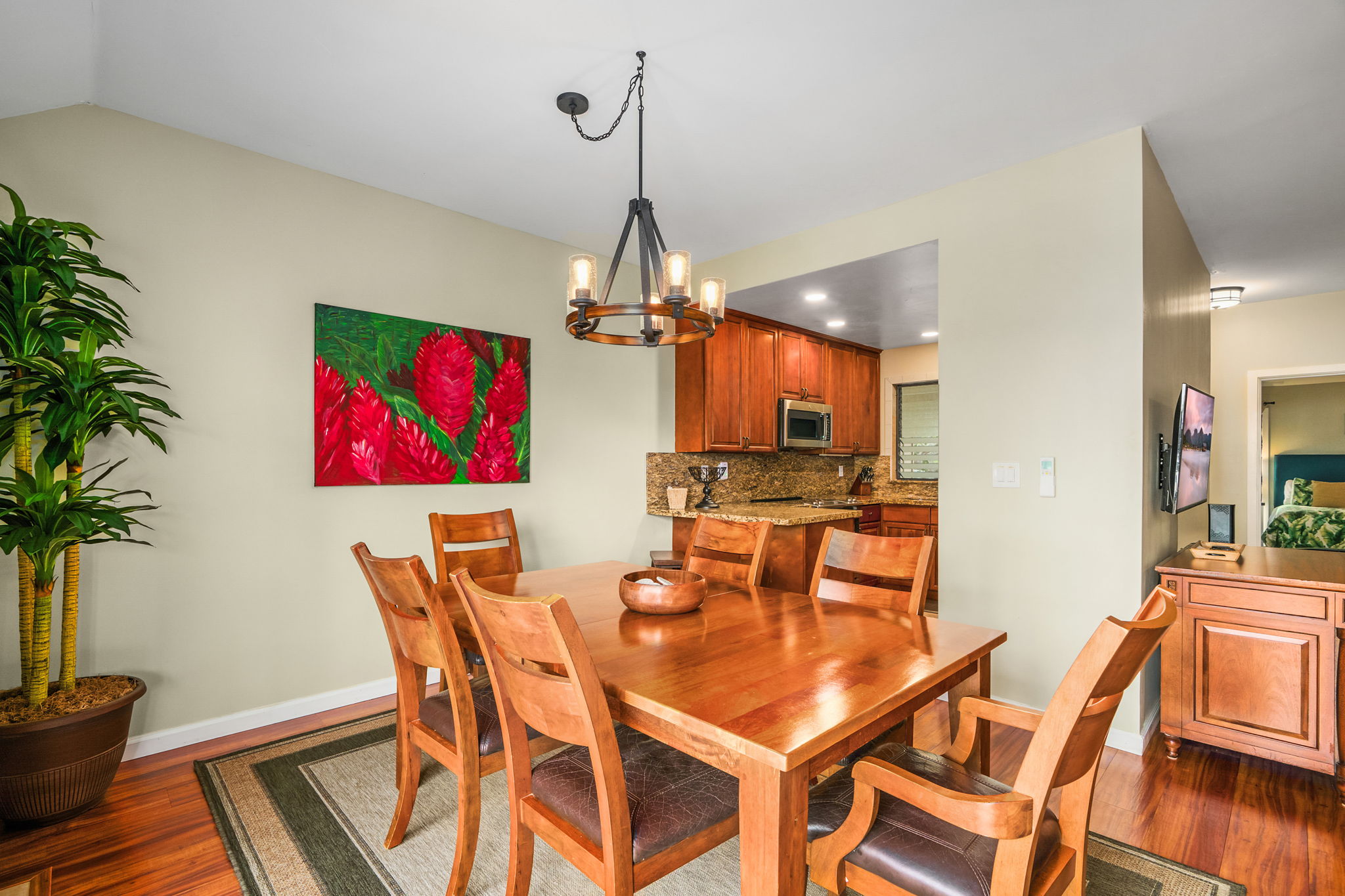 410 Papaloa Road, Unit 233 Kapaa, HI 96746 - Photo 11 of 27 a dining room with furniture a chandelier and wooden floor