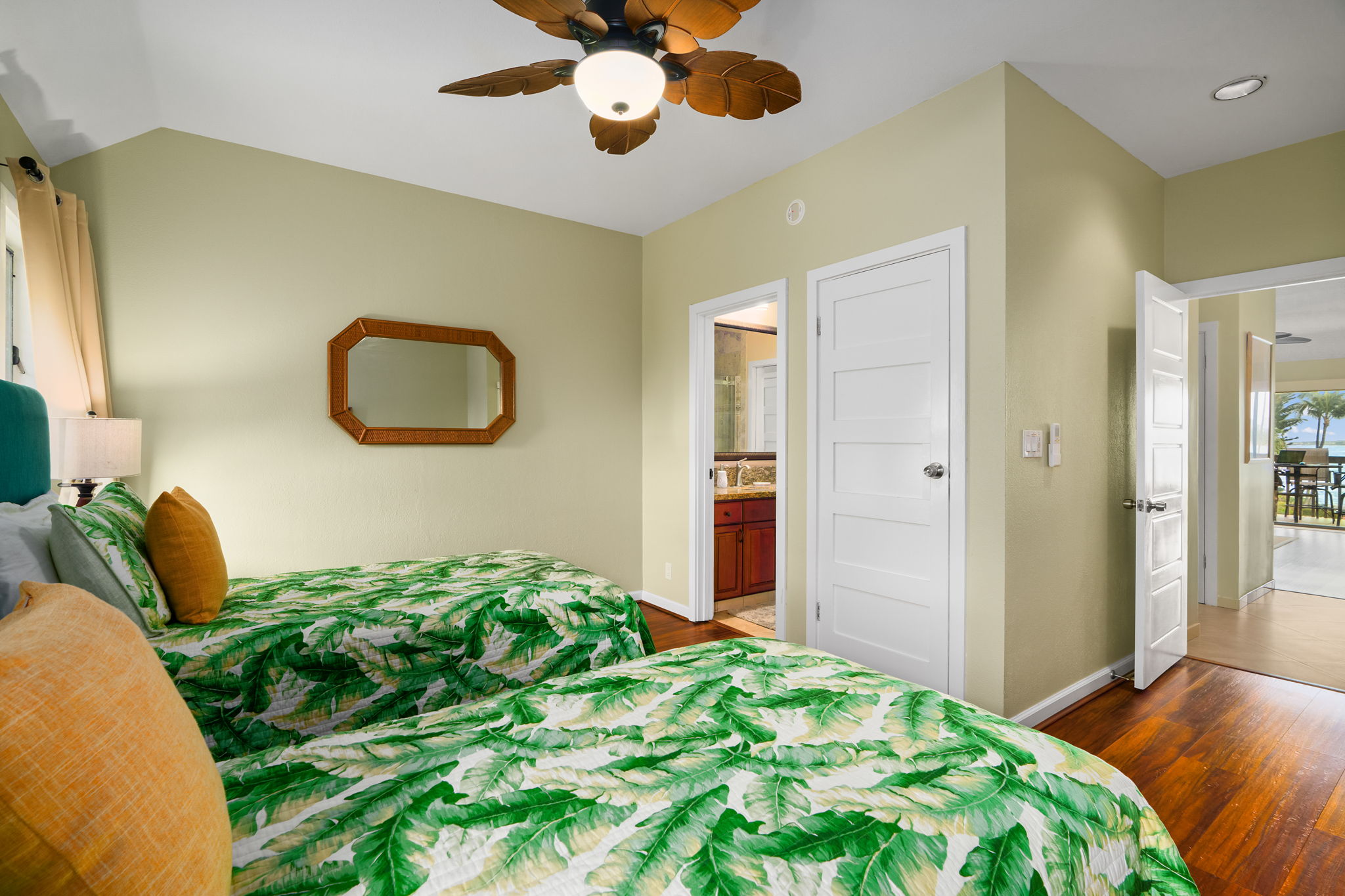 410 Papaloa Road, Unit 233 Kapaa, HI 96746 - Photo 17 of 27 a bedroom with a bed and a chandelier