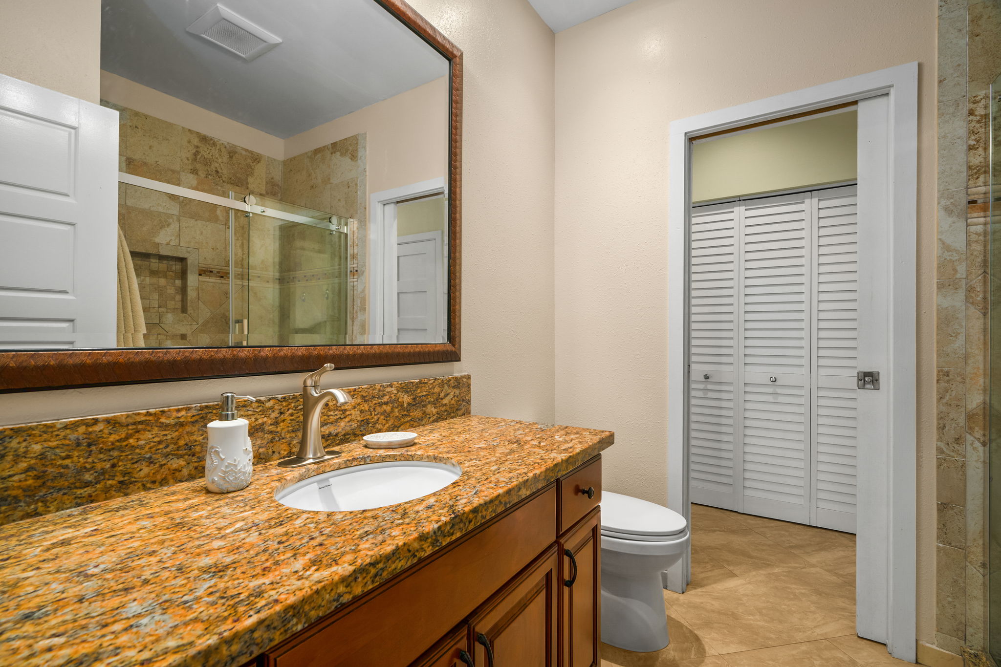 410 Papaloa Road, Unit 233 Kapaa, HI 96746 - Photo 19 of 27 a bathroom with a granite countertop sink and a mirror