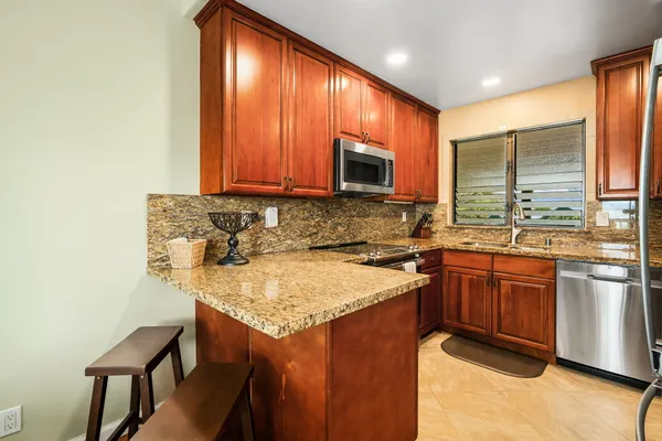 a kitchen with a sink stove and cabinets