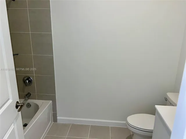 a bathroom with a granite countertop toilet a sink and bathtub