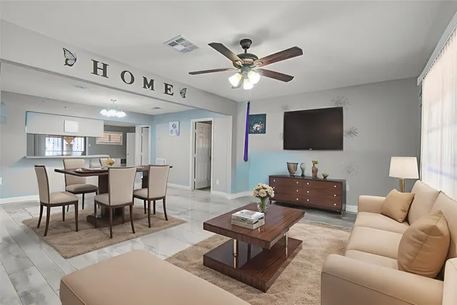 a living room with furniture a rug and a flat screen tv