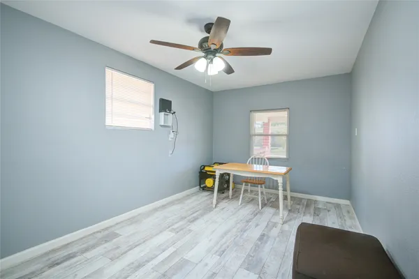 a workspace with wooden floor and a window