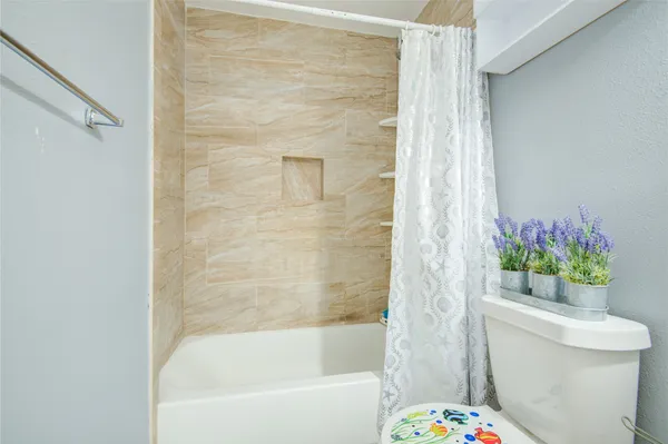 a bathroom with a bathtub and toilet