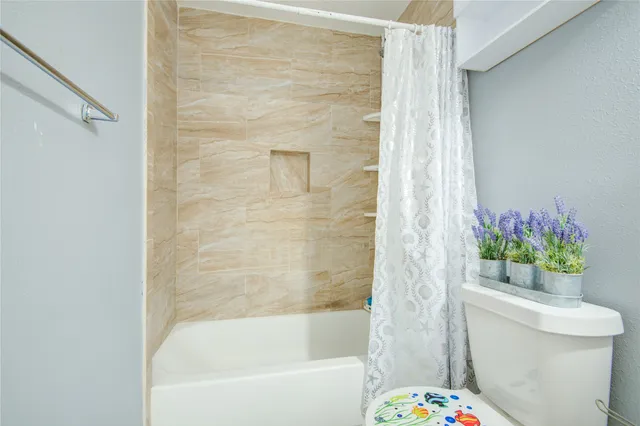 a bathroom with a bathtub and toilet