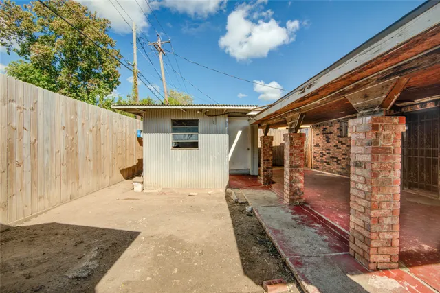 a view of a porch with a table and chairs