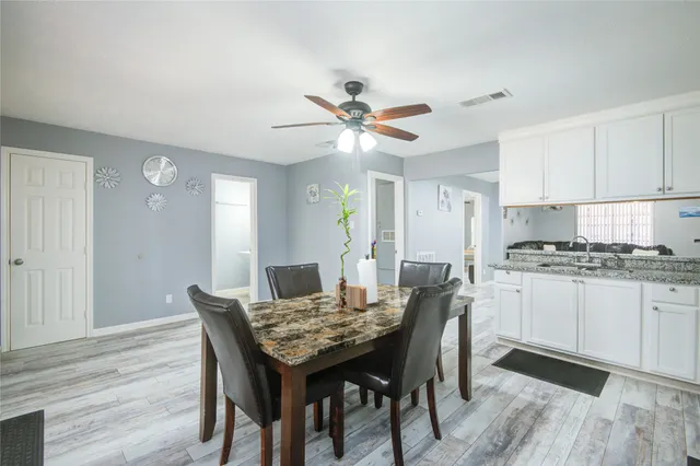 a view of a dining room with furniture and wooden floor