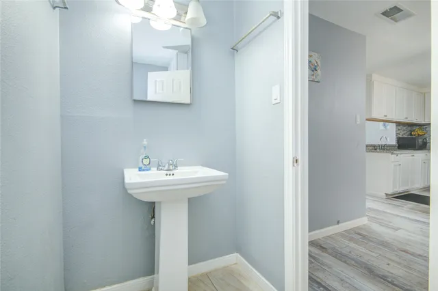 a bathroom with a sink a mirror and a shower