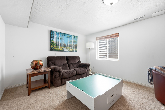 5196 Rodeo Circle Oakley, UT 84055 - Photo 35 of 57 Carpeted living space with white walls and a single window featuring horizontal blinds