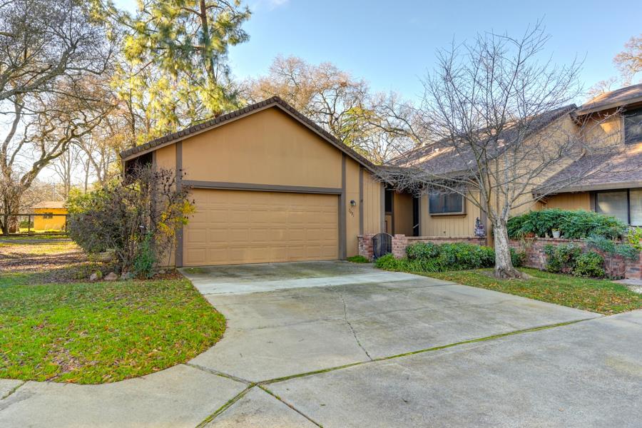 a view of backyard of house and garage