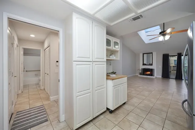 a view of a kitchen with a sink and a refrigerator