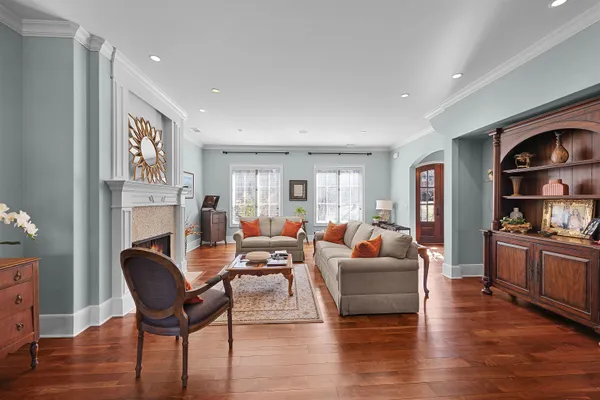 a living room with fireplace furniture and wooden floor