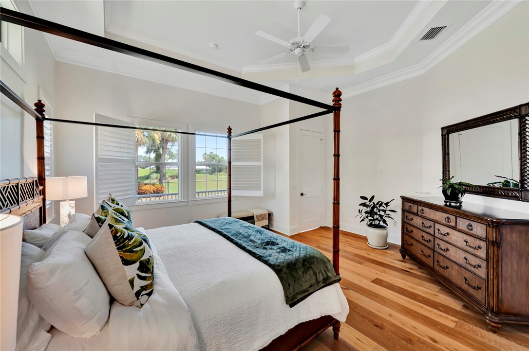 11 Caribe Way Vero Beach, FL 32963 - Photo 16 of 31 a bedroom with a bed and wooden floor