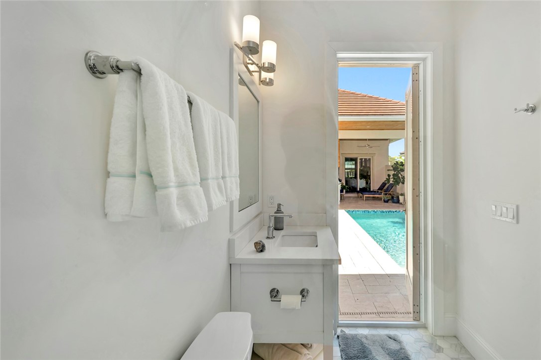 11 Caribe Way Vero Beach, FL 32963 - Photo 20 of 31 a bathroom with a sink vanity mirror and toilet