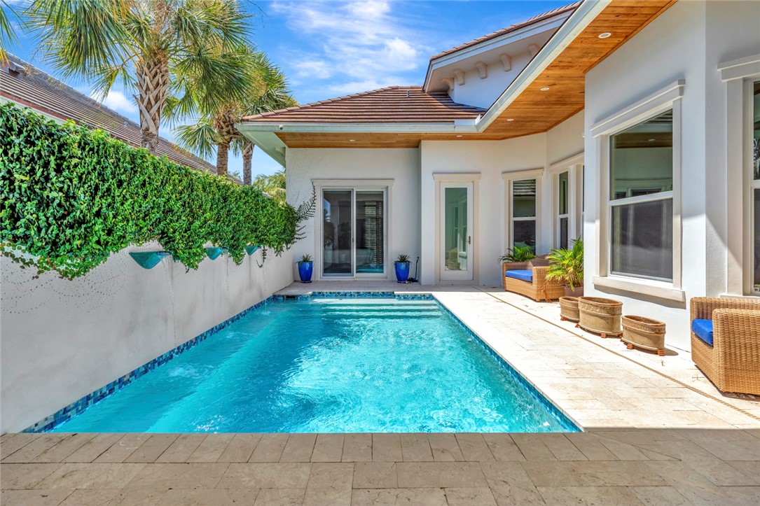 11 Caribe Way Vero Beach, FL 32963 - Photo 21 of 31 a view of a house with small yard plants and palm trees