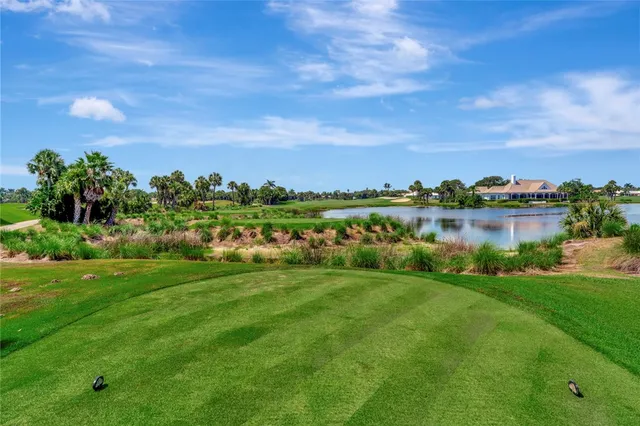 a view of a lake with houses in the back