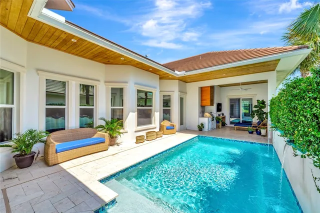 a view of a house with backyard porch and sitting area