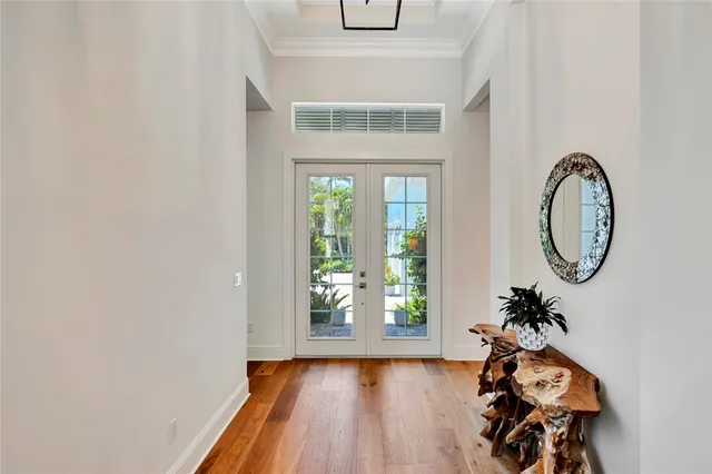 a view of a hallway with wooden floor and a window