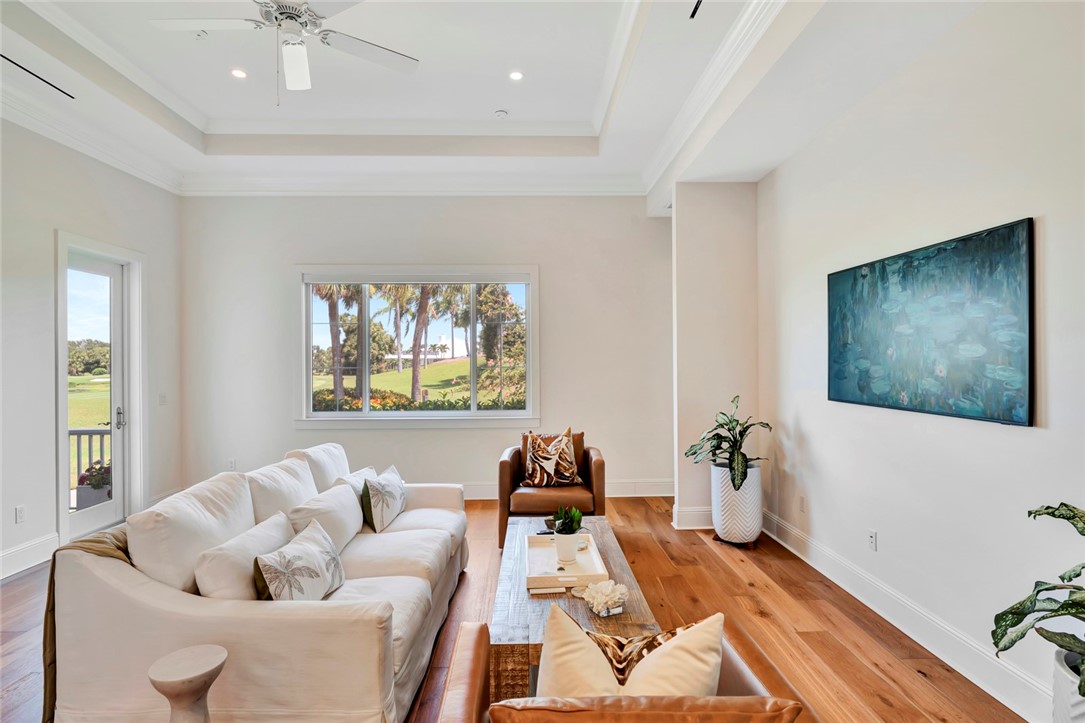 11 Caribe Way Vero Beach, FL 32963 - Photo 9 of 31 a living room with furniture and a flat screen tv