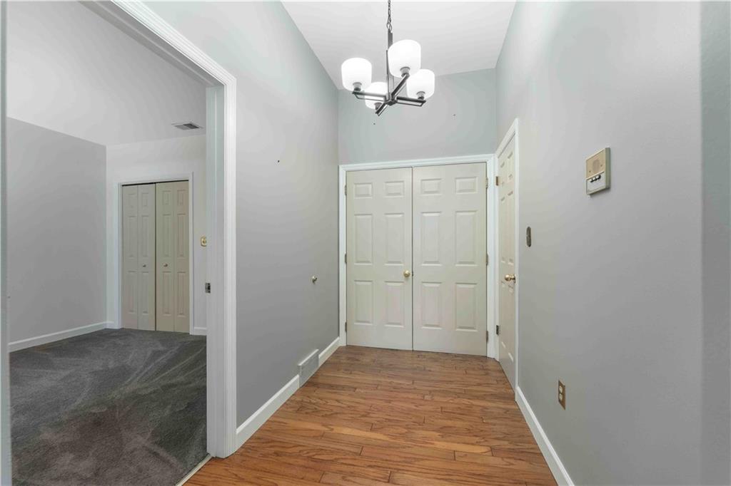 363 4th Street, Unit 6 Beaver, PA 15009 - Photo 6 of 34 The freshly painted, warm hardwood greets you as you enter, with a coat closet to the right and Guest Bedroom to the left.