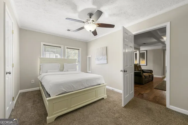 a bedroom with a bed and ceiling fan