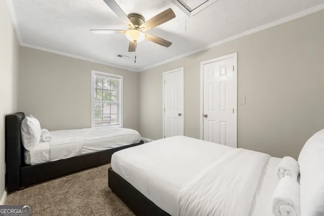 a bedroom with two beds and a chandelier