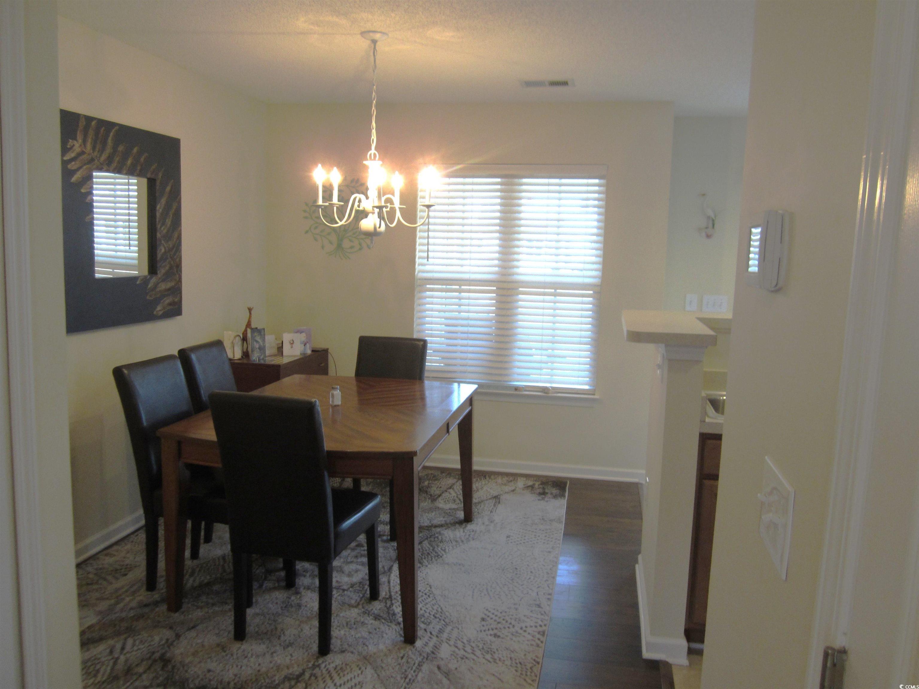1071 Pinwheel Loop, Unit 1071 Myrtle Beach, SC 29577 - Photo 13 of 39 Dining area featuring dark hardwood / wood-style f