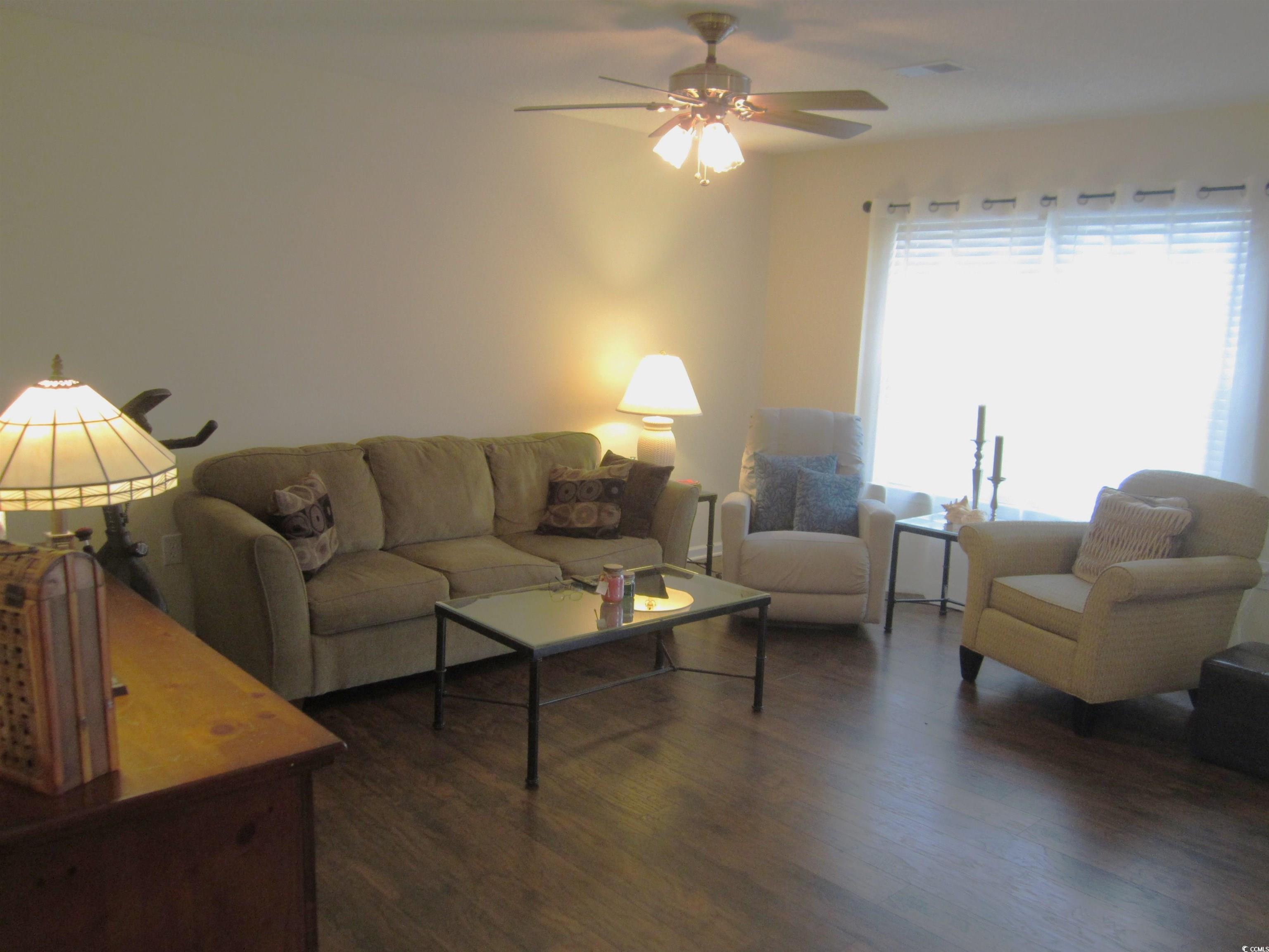 1071 Pinwheel Loop, Unit 1071 Myrtle Beach, SC 29577 - Photo 2 of 39 Living room featuring ceiling fan and dark wood-ty